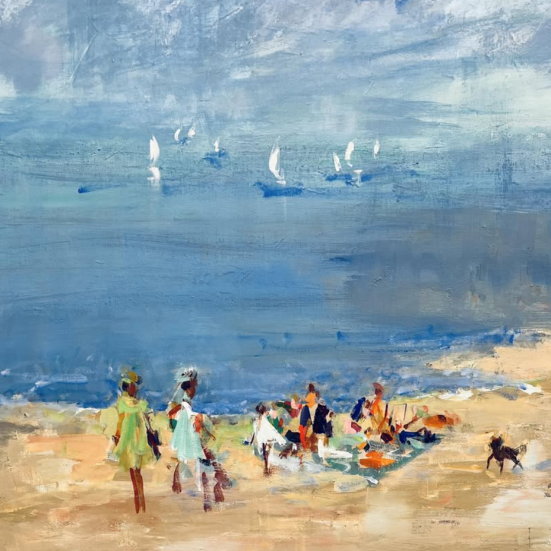 People stroll along a beach, while others relax on blankets. Sailboats dot the calm sea under a cloudy sky.